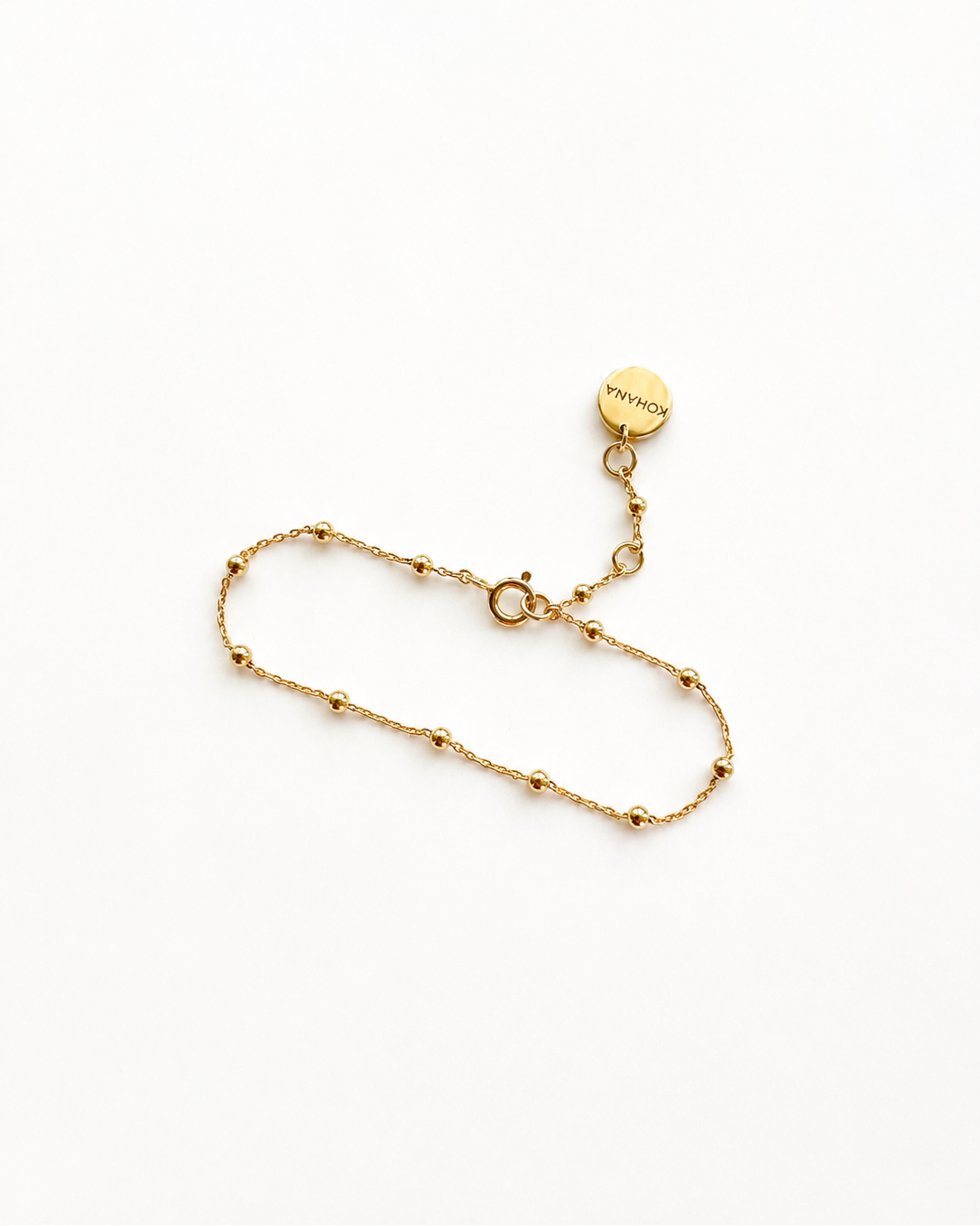 A delicate gold chain bracelet with small bead accents 